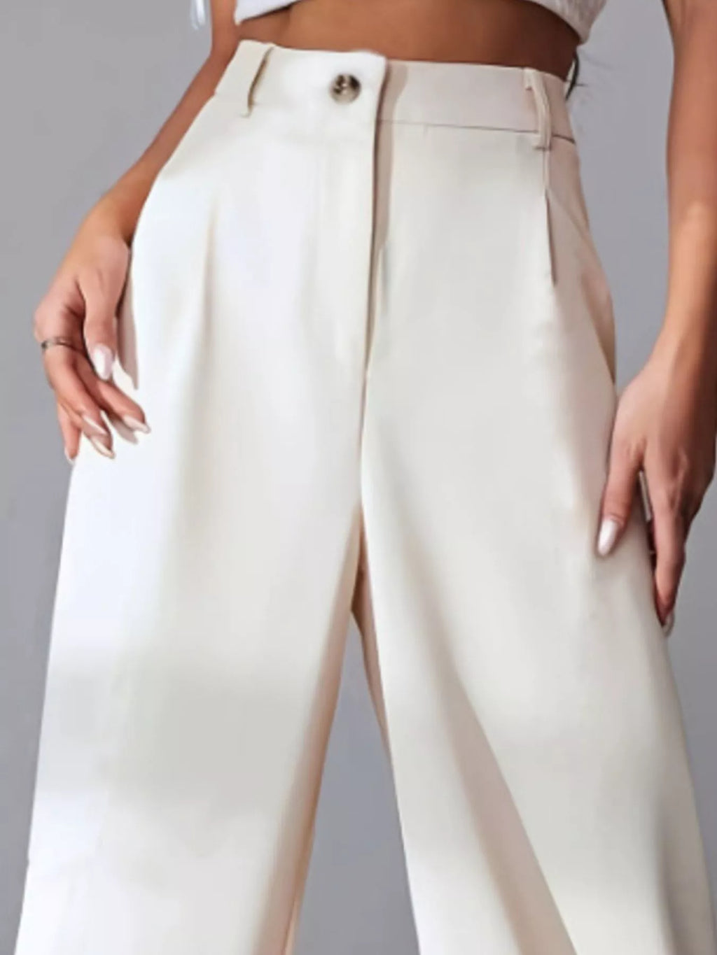 Pleated pants with button closure detail view